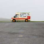 Emily-May Stephenson - Image of an ice cream van parked in an empty car park with a foggy field in the background.