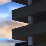 Billy Easton - Close up of the corner of a building, the sky is cut into diamond shapes